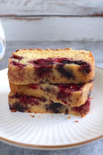 Easy triple berry cake slices on a plate